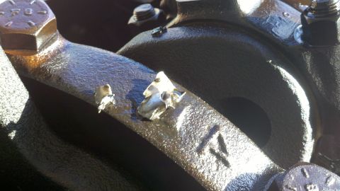 1978 Ford Bronco - Engine crankshaft bearing cap shows damage to two of its bolts.
