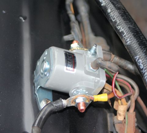 1976 Ford Ranchero - Close-up of a starter solenoid and associated wiring, with a black hose visible.
