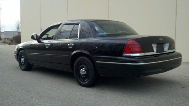 Black 2004 Ford Crown Victoria, rear passenger side view