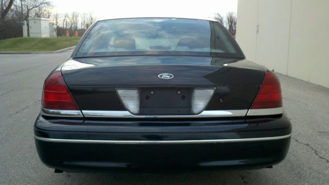 Rear view of a black Ford Crown Victoria sedan with chrome trim.