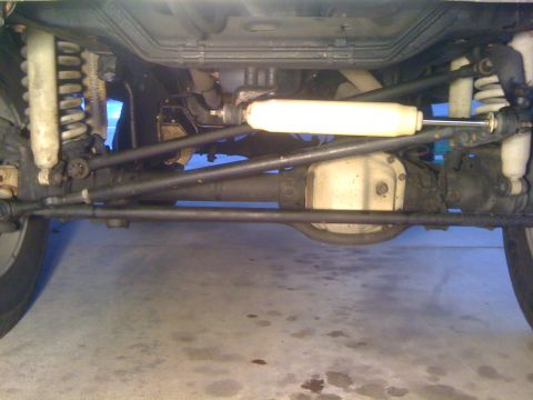 1979 Ford Bronco - Undercarriage view of a vehicle's suspension and drivetrain components.