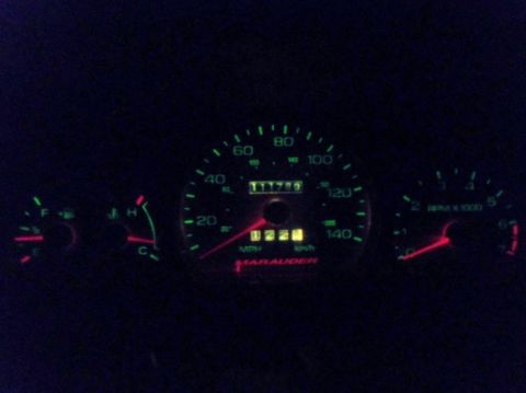 2000 Mercury Grand Marquis - The illuminated dashboard displays the speedometer, odometer, and tachometer readings in a dark interior.
