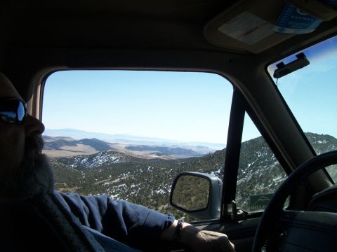 1996 Ford Bronco - Man drives through a mountainous landscape, with a view from inside the vehicle's cabin.