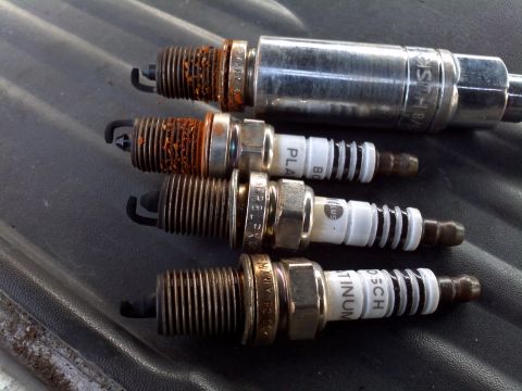 1999 Dodge 1500 - A collection of used spark plugs, showing varying degrees of wear and fouling.