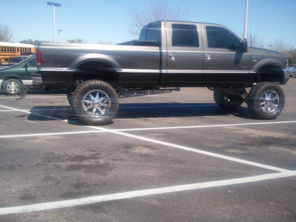 2007 Ford F-250 lifted pickup truck, side view
