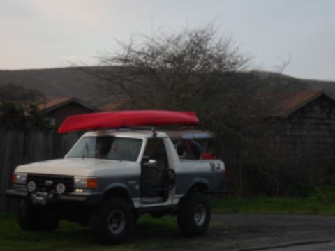 1991 Ford Bronco - This Ford Bronco is equipped for an outdoor adventure, carrying kayaks on its roof and in the bed.