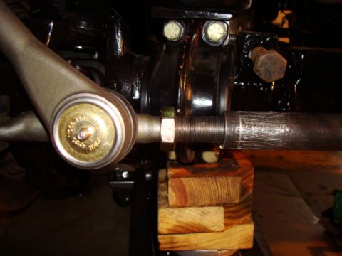 1995 Ford Bronco - This photo shows a close-up view of a vehicle's steering linkage system, supported by wooden blocks.