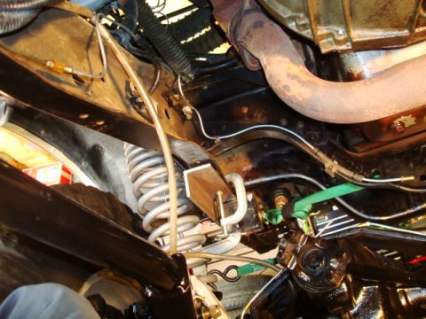 1995 Ford Bronco - Close-up view of a vehicle's undercarriage, focusing on suspension and brake components.