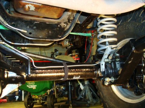 1995 Ford Bronco - Close-up view of the undercarriage, focusing on suspension and brake system parts, with a visible watermark.