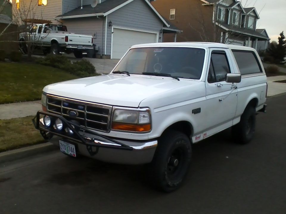 White 1992 Ford Bronco 3q-front view with aftermarket bumper and lights