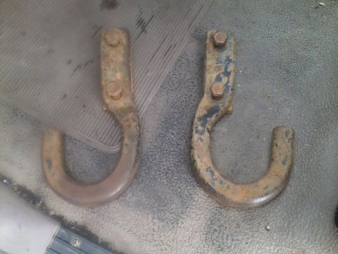 1992 Ford Bronco - Pair of used tow hooks, showing significant rust and wear.