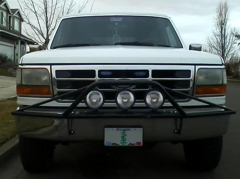 1992 Ford Bronco - Front view of a white 1992 Ford Bronco, equipped with a brush guard and auxiliary lights.