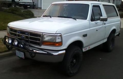 1992 Ford Bronco - White 1992 Ford Bronco parked on street, front 3/4 view.