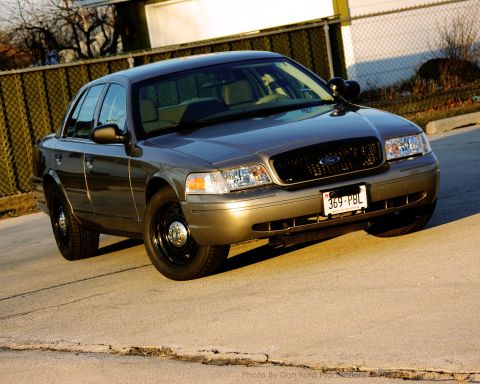 2005 Ford Crown Victoria - This Ford Crown Victoria is seen from a three-quarter front view, parked on a paved surface.