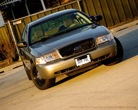 2005 Ford Crown Victoria - A 2005 Ford Crown Victoria is parked on a street, viewed from the front right.