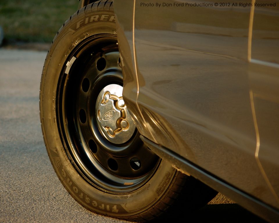 2005 Ford Crown Victoria side view with Firestone tire and Ford hubcap