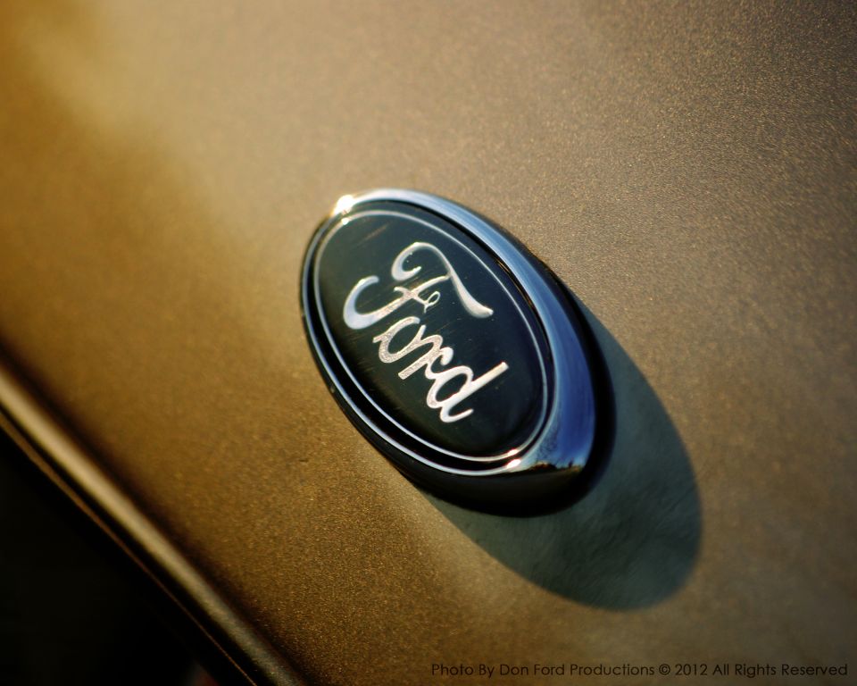 Close-up of Ford emblem on a gold car