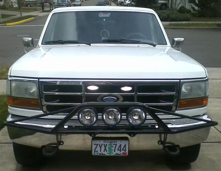 White 1992 Ford Bronco front view with aftermarket bumper and lights