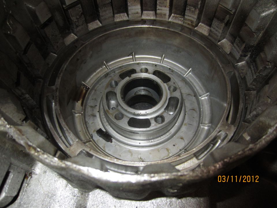Transmission torque converter housing interior, metal, with visible wear and oil residue