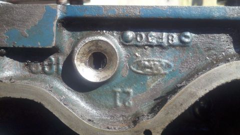 1978 Ford Bronco - Close-up of an engine block casting showing stamped Ford branding and part numbers.