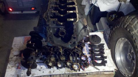 1978 Ford Bronco - Disassembled engine components are spread out, suggesting a rebuild or repair process is underway.