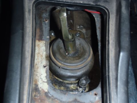 1978 Nissan 300ZX - Close-up view of a vehicle's gear shifter assembly, showing wear and tear.