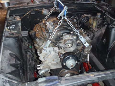 1978 Nissan 300ZX - Engine installation in progress, showing the engine bay and the engine suspended by chains.