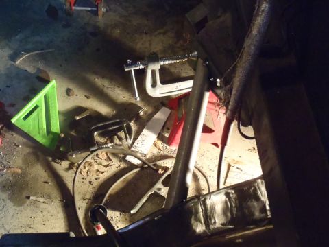 1978 Nissan 300ZX - A cluttered garage floor displays various tools and clamps, suggesting ongoing work or repairs.