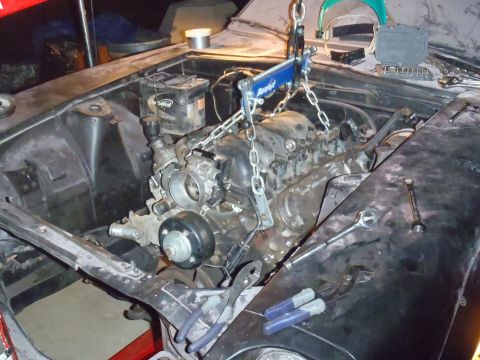 1978 Nissan 300ZX - The engine is suspended by a chain hoist, ready for removal or installation.