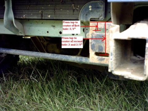 1995 Ford Bronco - Close-up of a vehicle's rear bumper mounting bracket, showing dimensions for two holes.