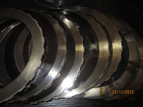 1979 Ford Bronco - A close-up view of multiple transmission clutch plates, likely for a rebuild or repair.