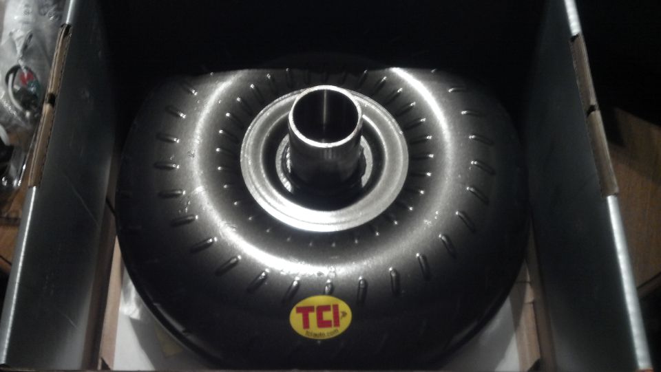 TCI torque converter in a box, showing the front with a metal hub and a circular pattern of studs