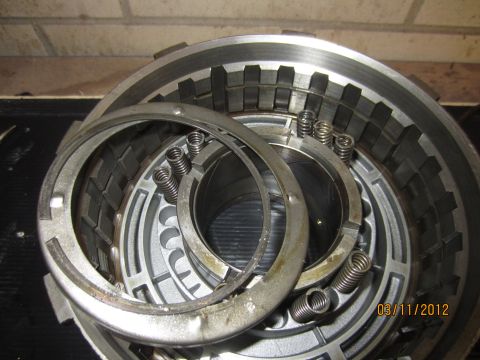 1979 Ford Bronco - Close-up view of a transmission clutch pack, showing internal components like springs and metal plates.