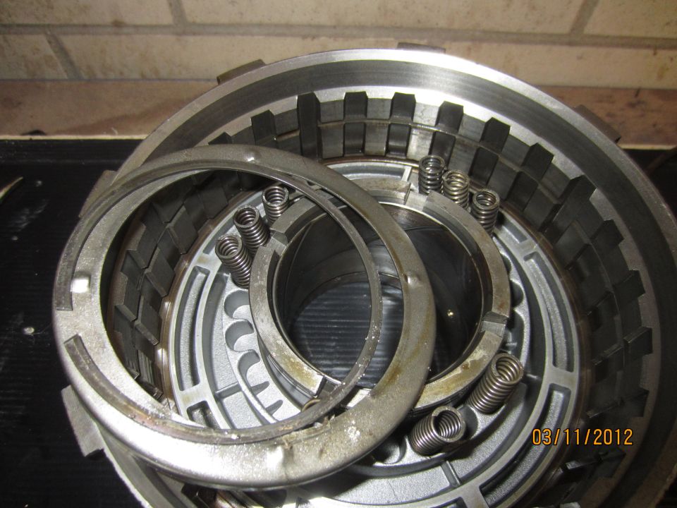 Transmission clutch pack with springs and metal plates