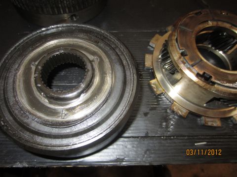 1979 Ford Bronco - Close-up of worn transmission components, including a clutch pack and splined shaft.