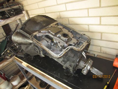 1979 Ford Bronco - An automatic transmission is shown disassembled on a workbench, revealing its internal workings.