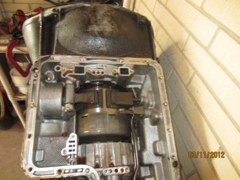 1979 Ford Bronco - Close-up view of an open automatic transmission, revealing the torque converter and other internal parts.