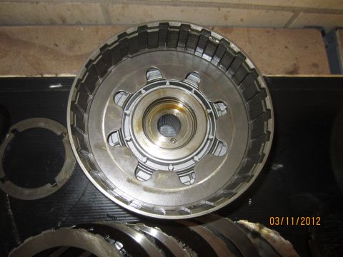 1979 Ford Bronco - A transmission clutch pack, showing friction discs and steel plates, is laid out for inspection or rebuild.