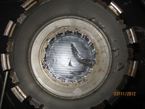 1979 Ford Bronco - Close-up of a damaged transmission clutch pack showing torn metal and wear.