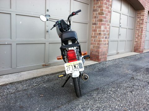 1999 Tomos Targa - Moped with a New Jersey license plate parked in front of a garage.
