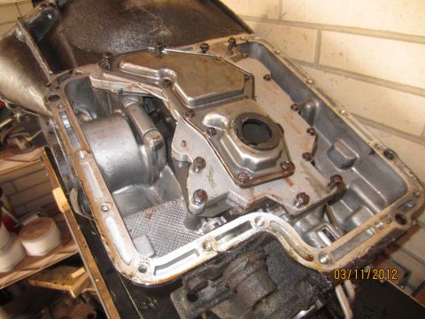 1979 Ford Bronco - Close-up view of a disassembled automatic transmission pan, revealing the filter and internal workings.