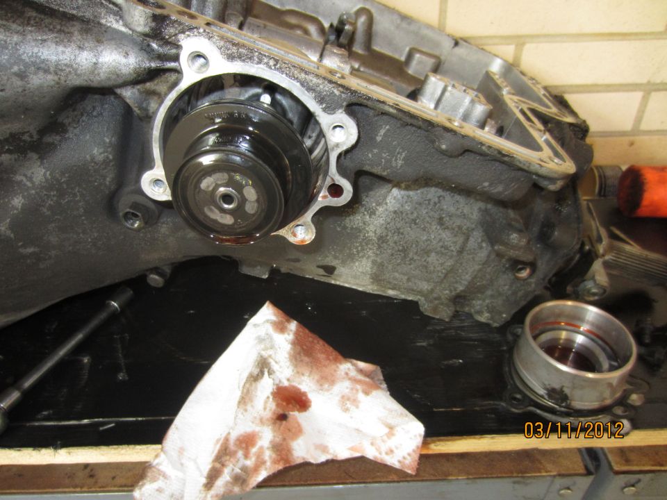 Transmission torque converter and housing with oil stains and a date stamp of 03/11/2012