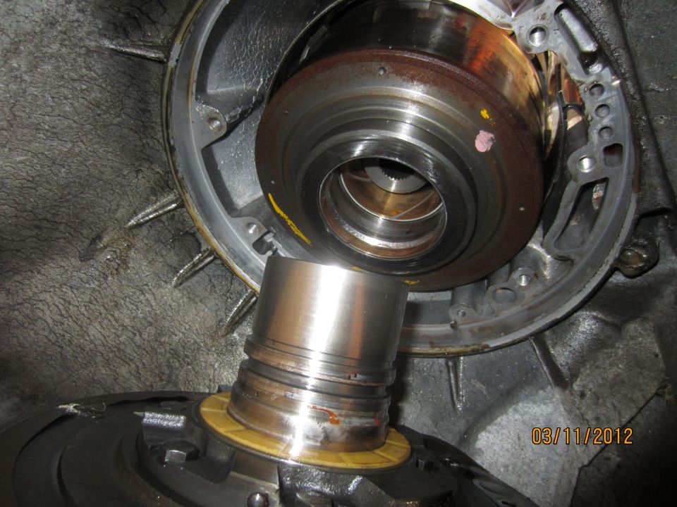 Close-up of a transmission torque converter and pump assembly, showing internal components and wear