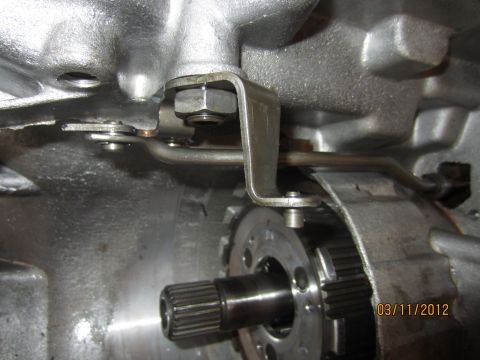 1979 Ford Bronco - A close-up view of the internal components of a vehicle's transmission, showing linkage and gears.