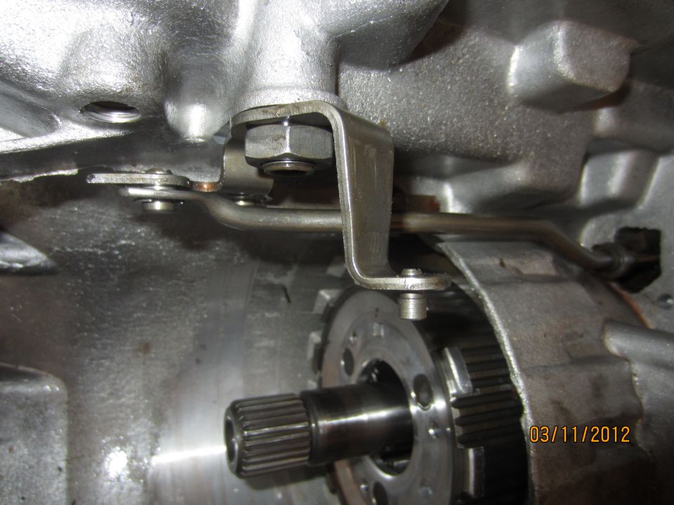 Close-up of transmission linkage and gears inside a vehicle's transmission housing