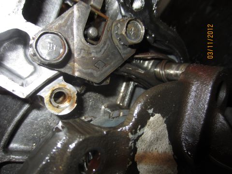 1979 Ford Bronco - Detail of a greasy mechanical component, possibly from a transmission, with visible bolts and levers.