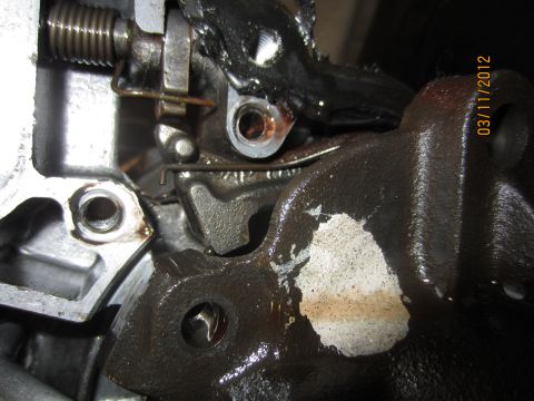 1979 Ford Bronco - A close-up view of a greasy transmission part, showing mechanical linkages and a date stamp.