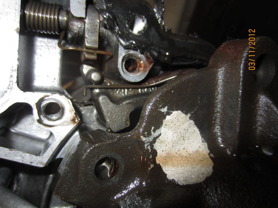 Close-up of a greasy, metallic transmission component with a date stamp