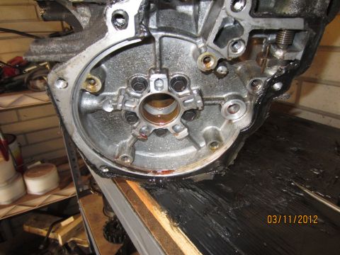 1979 Ford Bronco - Engine transmission housing detail with visible bolts and oil residue. Photo dated 03/11/2012.