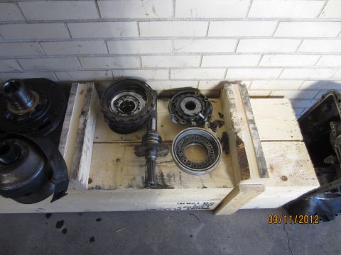 1979 Ford Bronco - Various transmission parts are organized within a wooden crate, suggesting a rebuild or repair process.